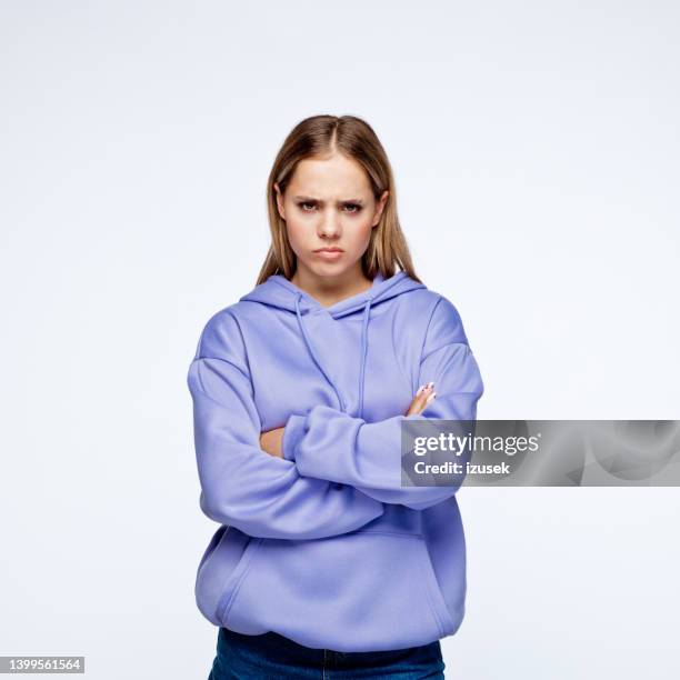 displeased teenage girl looking at camera - angry teenager stock pictures, royalty-free photos & images