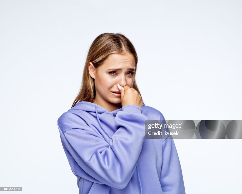 Displeased teenage girl looking at camera