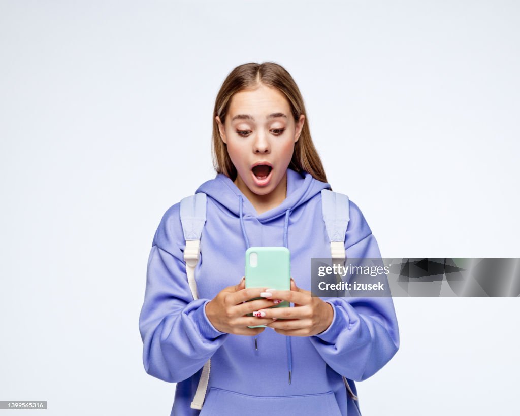 Surprised teenage girl wearing lilac hoodie