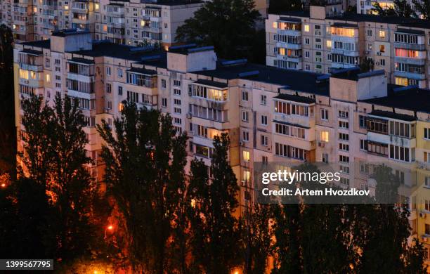 illuminated windows of residential district of kyiv cityscape. early night time. - kyiv night stock pictures, royalty-free photos & images