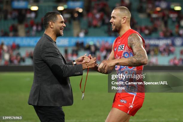 Lance Franklin of the Swans receives the Goodes-O'Loughlin medal from Michael O'Loughlin after winning the round 11 AFL match between the Sydney...