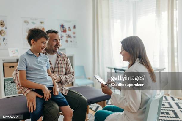 he feels no pain - family pediatrician stock pictures, royalty-free photos & images
