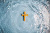 Wooden Cross surrounded with water Baptized by Christ