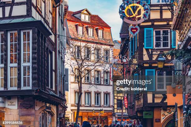 colorful christmas in colmar. traditional beautiful alsace buildings decorated with christmas ornaments . - colmar stockfoto's en -beelden