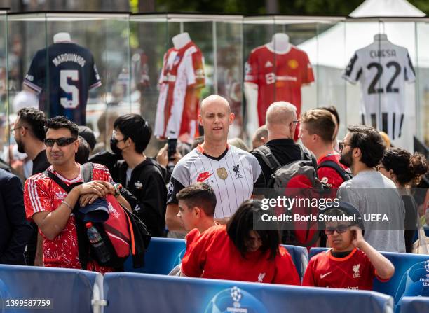 Fans wait in a queue to pose with the UEFA Champions League trophy at Hotel de Ville on day 2 of the UEFA Champions League Final 2021/22 Festival...