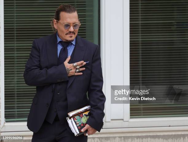 Actor Johnny Depp takes a break during his trial at a Fairfax County Courthouse on May 27, 2022 in Fairfax, Virginia. Closing arguments in the Depp...