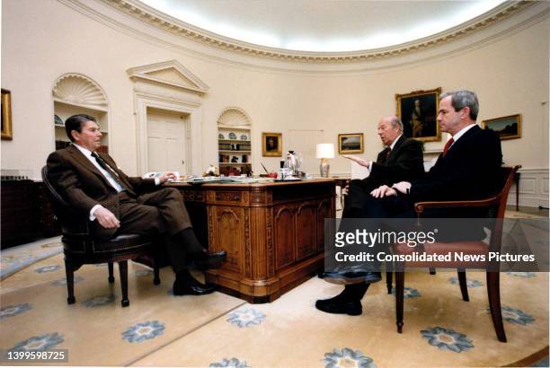 President Ronald Reagan meets with US Secretary of State George P Shultz and the President's assistant for National Security Affairs Robert C...