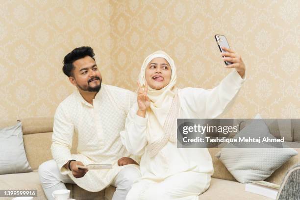 young brother & sister clicking selfie using a mobile phone. - father clicking selfie bildbanksfoton och bilder