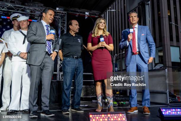 Hosts Brian Kilmeade, Katie Pavlich and Pete Hegseth with Lee Greenwood as he visits "FOX & Friends" at Fox News Channel Studios on May 27, 2022 in...
