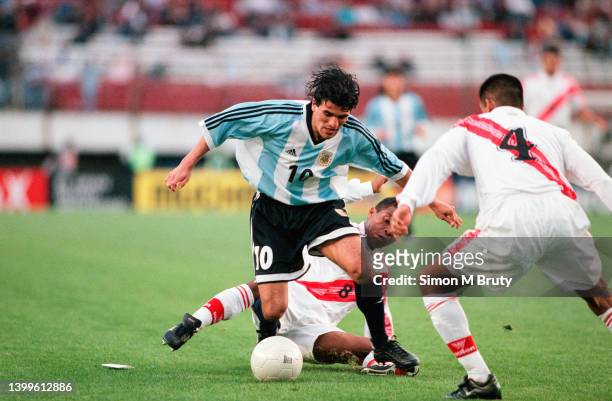 Ariel Ortega of Argentina and Martin Hidalgo of Peru in action during a FIFA World Cup Qualifying match between Peru and Argentina at the Estadio...