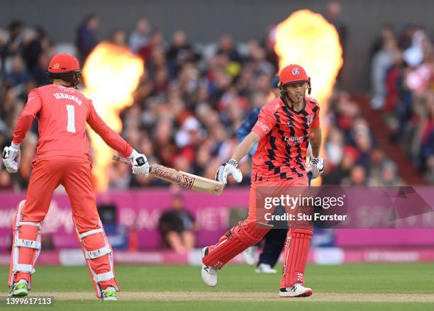 Lightning batsman Phil Salt celebrates a boundary as the flames light during the Vitality T20 Blast match between Lancashire Lightning and Yorkshire...