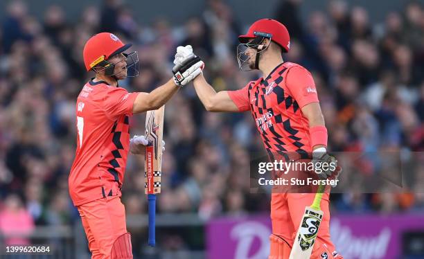 Lightning batsman Phil Salt reaches his 50 and is congratulated by Liam Livingstone during the Vitality T20 Blast match between Lancashire Lightning...