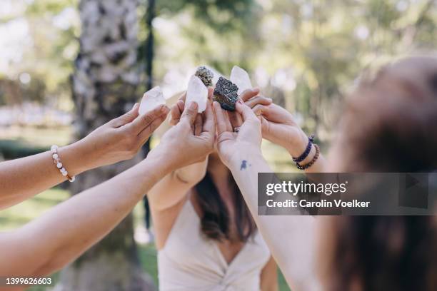 womens hands in an outdoors crystal ceremony - quartz stockfoto's en -beelden