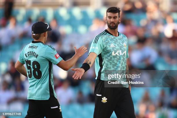 Reece Topley of Surrey celebrates with team mate Sam Curran after taking the wicket of Sam Northeast of Glamorgan during the Vitality T20 Blast match...