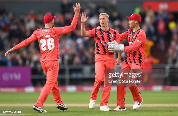 Lightning bowler Luke Wood is congratulated by team mates after bowling Adam Lyth during the Vitality T20 Blast match between Lancashire Lightning...