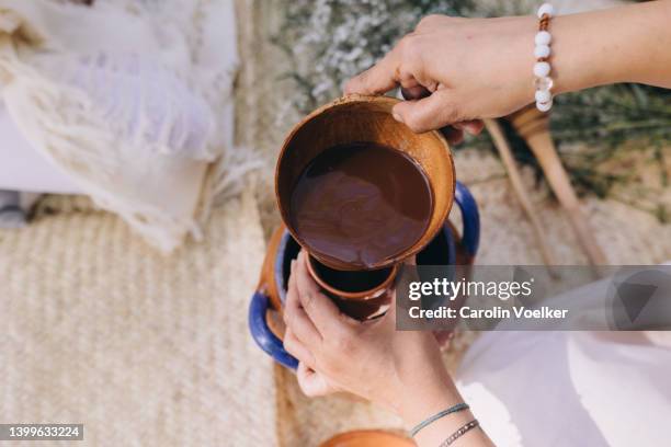 high angle view of a cacao drink in a woman hands - cacao foto e immagini stock