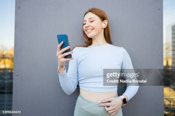 sporty woman with wireless earbuds - sportswear shopping stock pictures, royalty-free photos & images