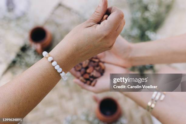 high angle view of hands holding cacao beans - ceremony stockfoto's en -beelden