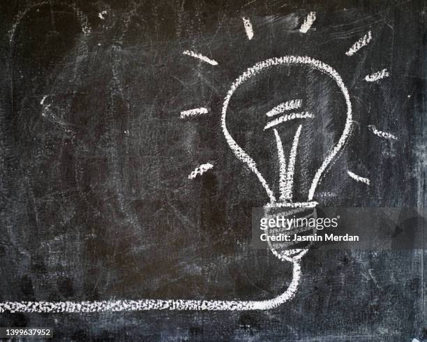 light bulb on blackboard - intellectual property stock-fotos und bilder