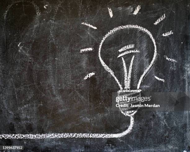 light bulb on blackboard - copyright stock pictures, royalty-free photos & images