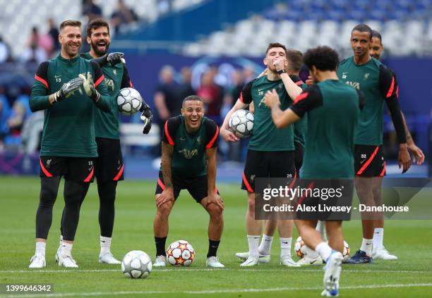 Thiago Alcantara, Alisson Becker, Adrian and Andrew Robertson of Liverpool react towards Mohamed Salah of Liverpool during an open training session...