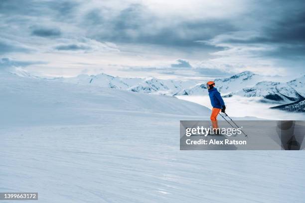 a skier skates along a low angle ski run in the high alpine of british columbia - whistler mountain stock pictures, royalty-free photos & images