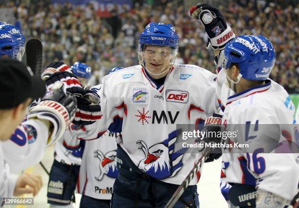 Denis Reul of Mannheim jubilates with team mates after scoring the first goal during the DEL Bundesliga match between EHC Eisbaeren Berlin and Adler...