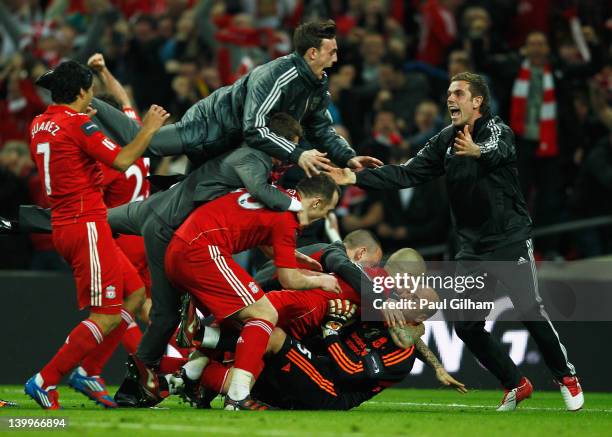 Goalkeeper Jose Reina of Liverpool is mobbed by team mates as they celebrate their penalty shoot out victory after the Carling Cup Final match...