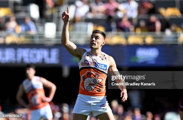 Stephen Coniglio of the Giants celebrates after kicking a goal during the round 11 AFL match between the Brisbane Lions and the Greater Western...