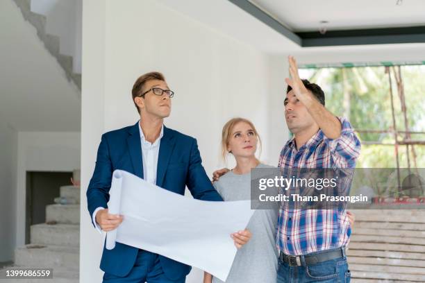 couple with real estate agent visiting property for viewing - move to new place stock pictures, royalty-free photos & images