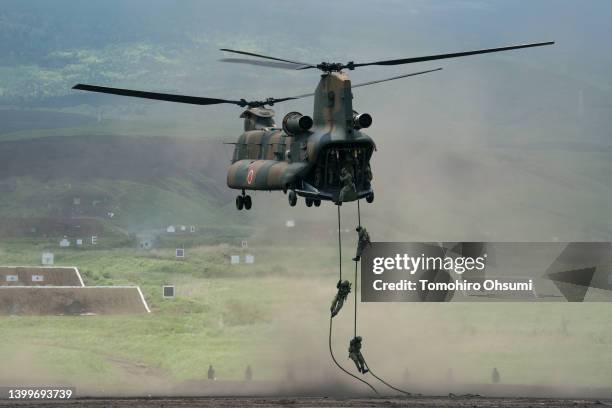 Members of the Japan Ground Self-Defense Force disembark from a CH-47 Chinook helicopter during a live fire exercise at East Fuji Maneuver Area on...