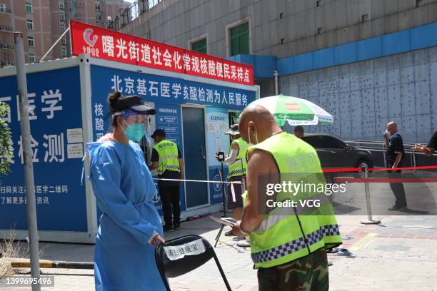 People queue up for COVID-19 nucleic acid tests in Haidian district during a new round of nucleic acid testing amid the COVID-19 resurgence on May...