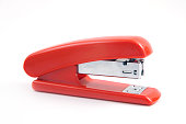 Red stapler on white background