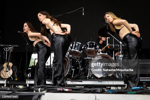 Alana, Danielle, and Este Haim of Haim perform onstage during the Boston Calling Music Festival on May 27, 2022 in Boston, Massachusetts.