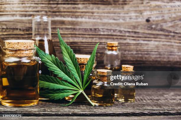 rows with cbd oil jars and cannabis leaves. - cannabis concentrate stock pictures, royalty-free photos & images