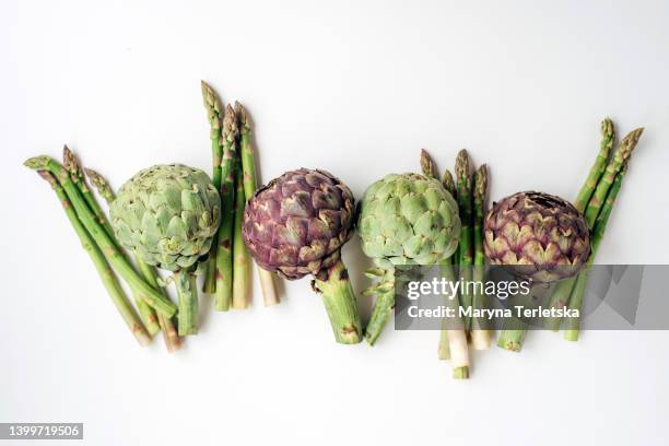 asparagus and artichokes on a white background. exotic vegetables. healthy food. farm harvest. dish ingredients. - spoil system stock pictures, royalty-free photos & images