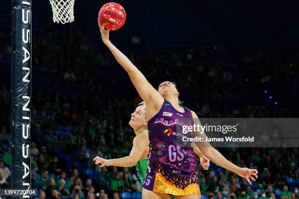 Donnell Wallam of the Firebirds reaches up for the ball during the round 12 Super Netball match between West Coast Fever and Queensland Firebirds at...