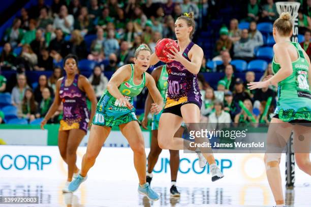 Gabi Simpson of the Firebirds looks to make the pass during the round 12 Super Netball match between West Coast Fever and Queensland Firebirds at RAC...