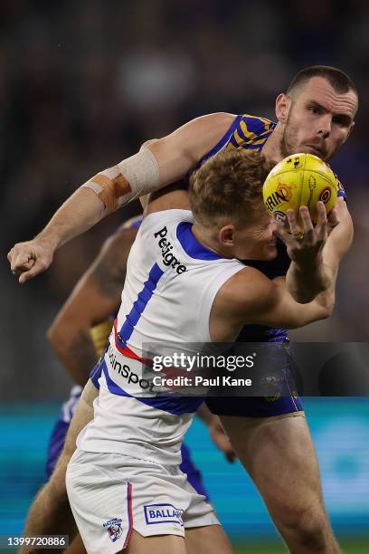 Luke Shuey of the Eagles handballs against Adam Treloar of the Bulldogs during the round 11 AFL match between the West Coast Eagles and the Western...