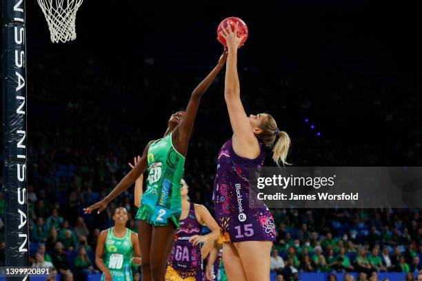 Donnell Wallam of the Firebirds reaches for the ball against Sunday Aryang of the Fever during the round 12 Super Netball match between West Coast...