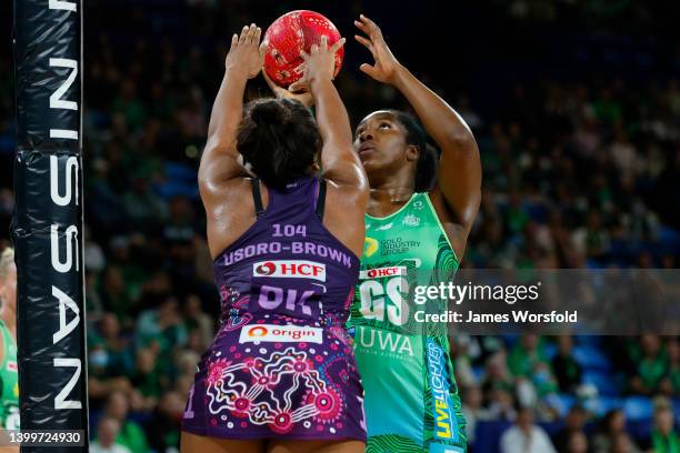 Jhaniele Fowler of the Fever shoots over Eboni Usoro-Brown of the Firebirds during the round 12 Super Netball match between West Coast Fever and...