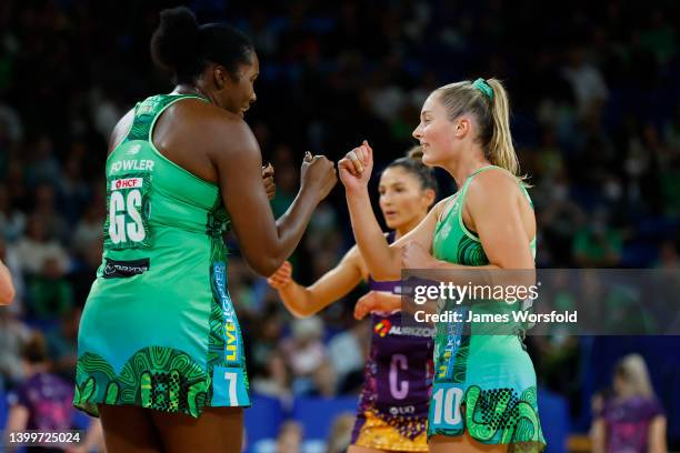 Jhaniele Fowler and Alice Teague-Neeld of the Fever bump fists after scoring a point during the round 12 Super Netball match between West Coast Fever...