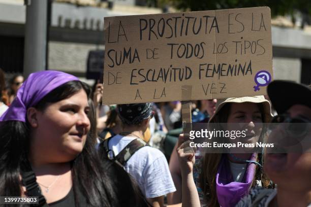 Person holds a banner reading: 'The prostitute is the sum of all types of female slavery at once', at a demonstration to demand the abolition of...