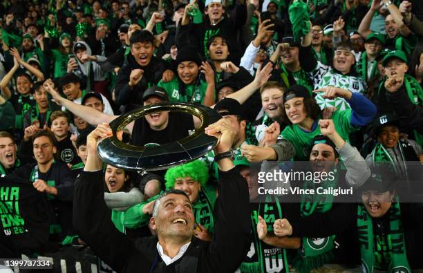Western United coach John Aloisi lifts the trophy in front of supporters after winning the A-League Mens Grand Final match between Western United and...