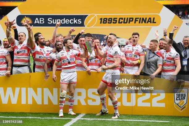 Joe Mellor and Adam Sidlow of Leigh Centurions lift the AB Sundecks 1895 Cup as their side celebrates after victory in the AB Sundecks 1895 Cup Final...