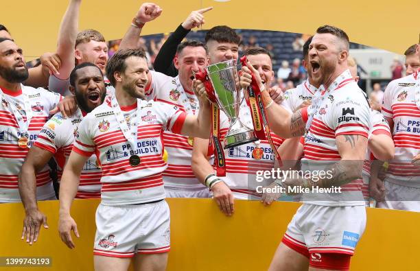 Joe Mellor and Adam Sidlow of Leigh Centurions lift the AB Sundecks 1895 Cup as their side celebrates after victory in the AB Sundecks 1895 Cup Final...