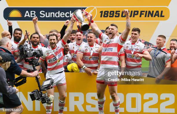 Joe Mellor and Adam Sidlow of Leigh Centurions lift the AB Sundecks 1895 Cup as their side celebrates after victory in the AB Sundecks 1895 Cup Final...