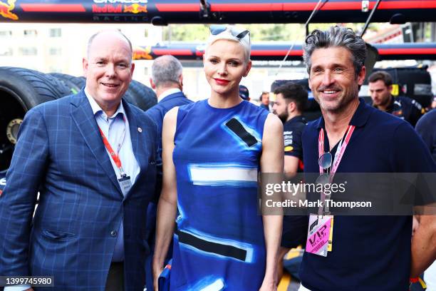 Prince Albert of Monaco Princess Charlene of Monaco and Patrick Dempsey pose for a photo outside the Red Bull Racing garage prior to qualifying ahead...