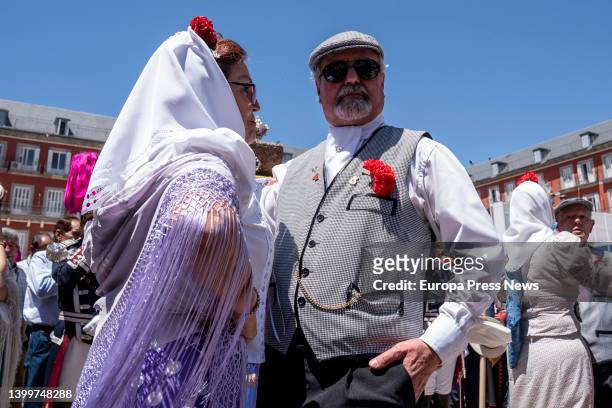 Couple of chulapos pay homage to the body of San Isidro as it passes through the Plaza Mayor, May 28 in Madrid, Spain. The incorrupt body of San...