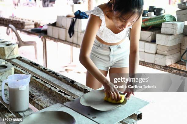 tourist in a pottery factory - indonesian ethnicity stock pictures, royalty-free photos & images